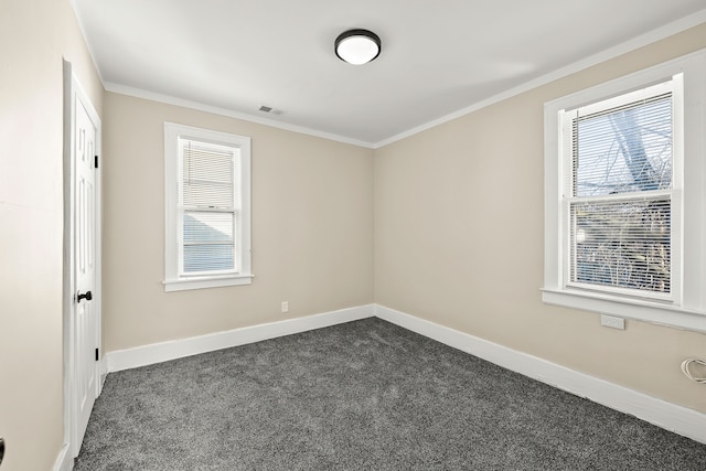 carpeted empty room with ornamental molding and plenty of natural light