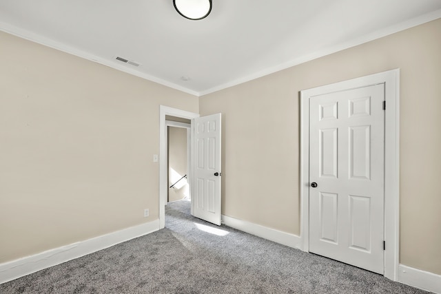 unfurnished bedroom featuring crown molding and carpet floors