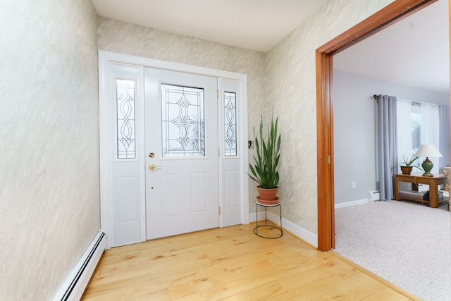 foyer entrance featuring baseboard heating and wood-type flooring