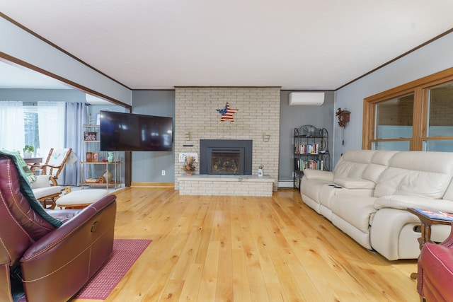 living room featuring hardwood / wood-style flooring, crown molding, a brick fireplace, and a wall mounted AC