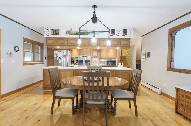 dining space featuring a baseboard radiator, light wood-type flooring, and crown molding