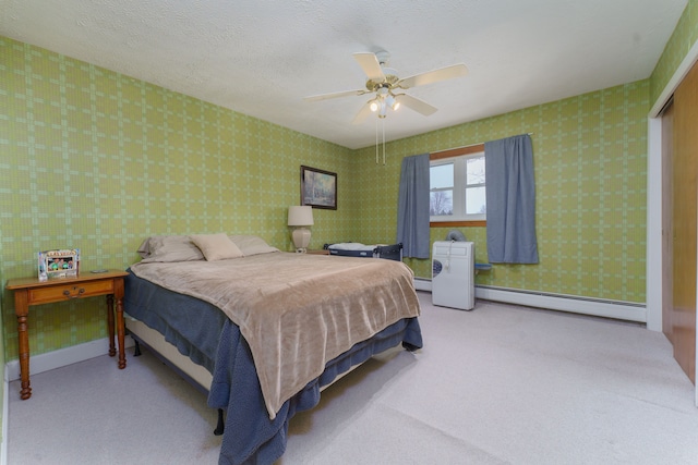 bedroom featuring ceiling fan, light carpet, a textured ceiling, and baseboard heating