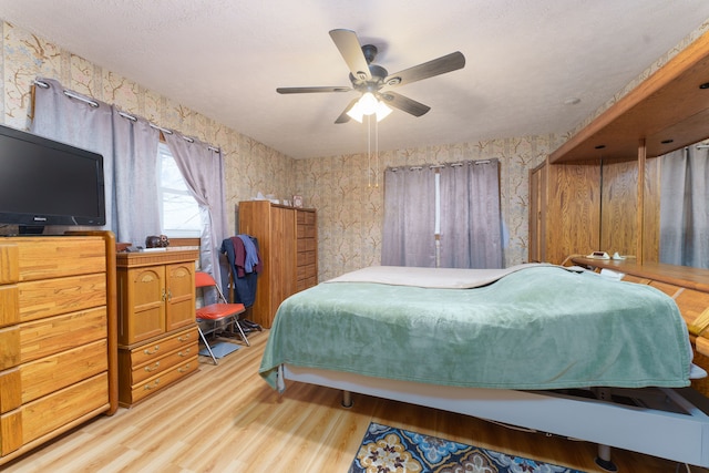 bedroom with ceiling fan and light hardwood / wood-style floors