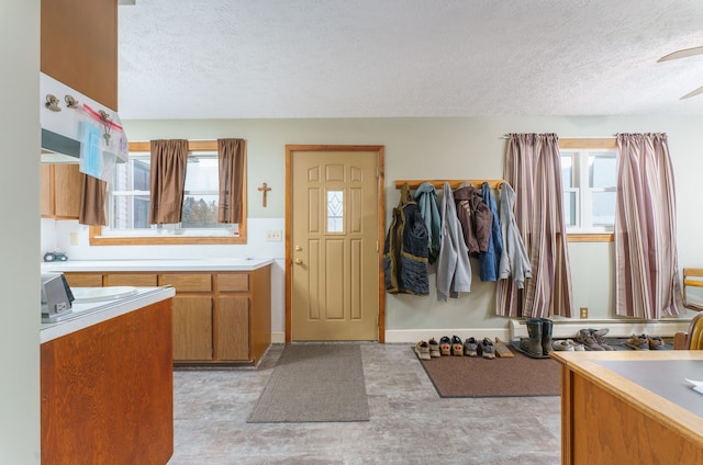 bathroom featuring a wealth of natural light and a textured ceiling