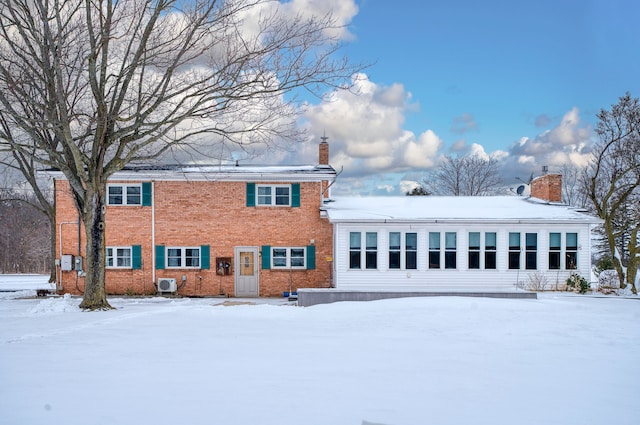 view of snow covered rear of property