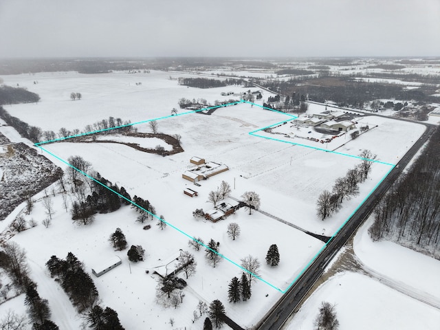 snowy aerial view featuring a rural view