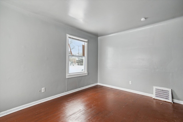 empty room featuring dark wood-type flooring