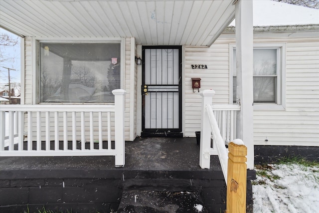 view of snow covered property entrance