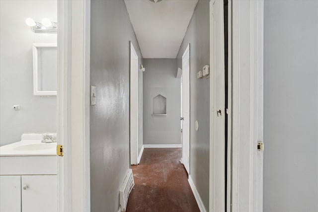 hallway featuring dark hardwood / wood-style floors and sink