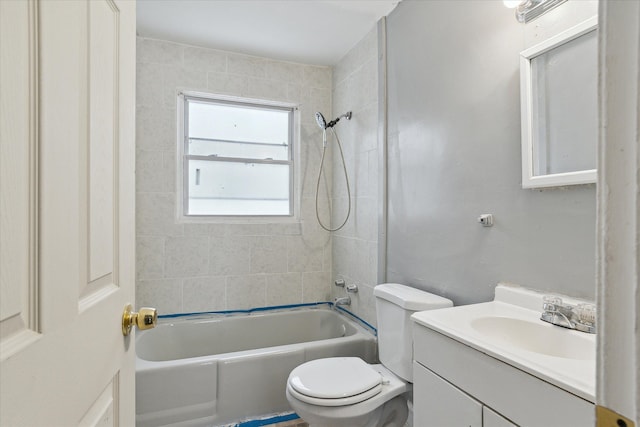 full bathroom with vanity, tiled shower / bath combo, and toilet