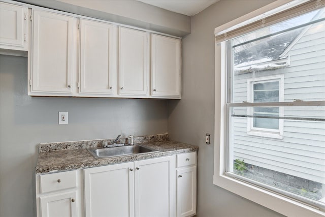 kitchen with white cabinetry and sink