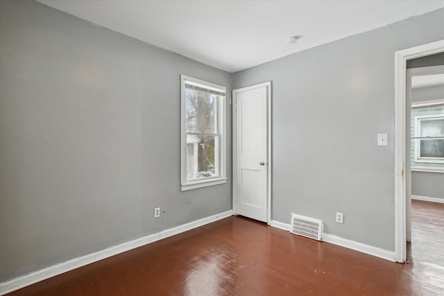 spare room featuring dark hardwood / wood-style flooring