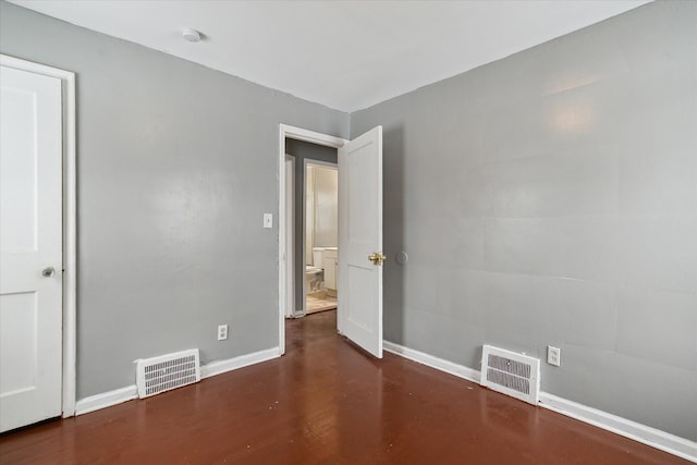 unfurnished room featuring dark hardwood / wood-style flooring