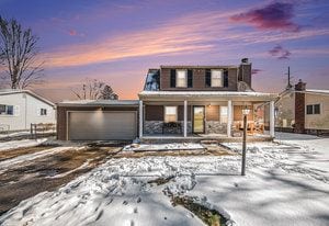 view of front of property with covered porch and a garage