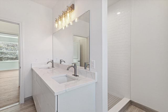 bathroom featuring hardwood / wood-style floors, vanity, and walk in shower