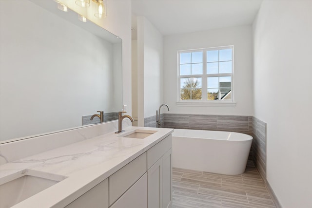 bathroom with vanity and a bathtub