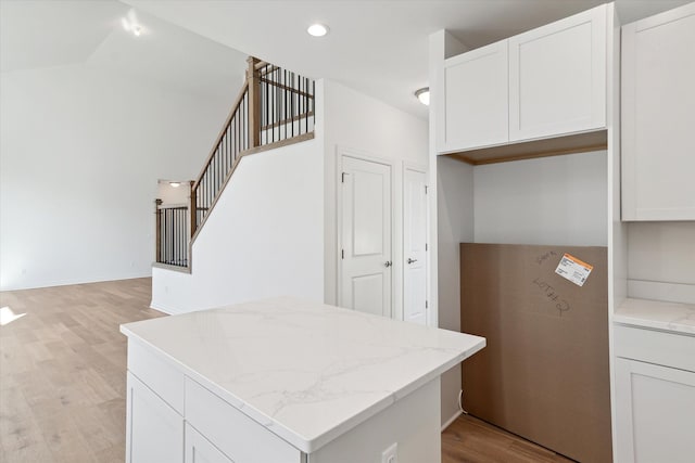 kitchen with white cabinetry and light hardwood / wood-style flooring