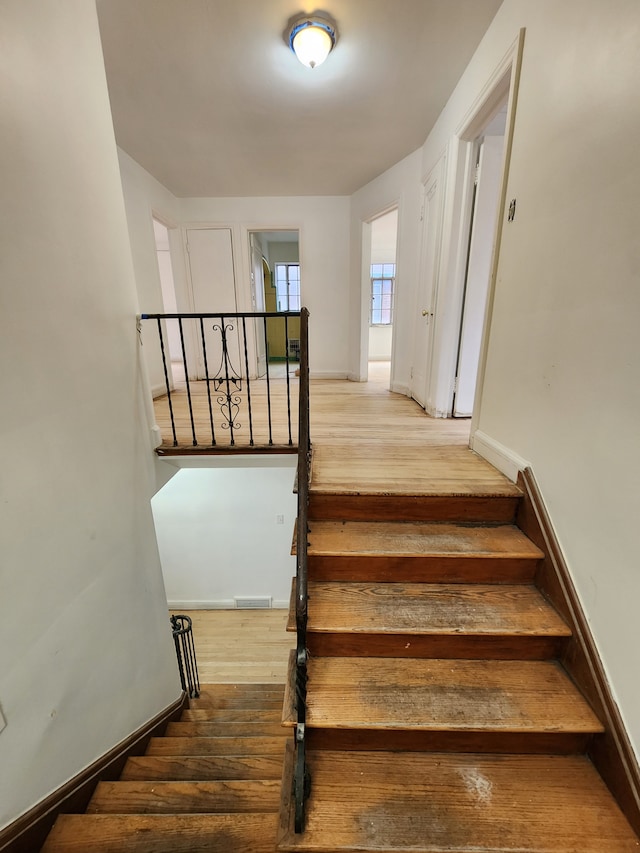 stairs with hardwood / wood-style floors