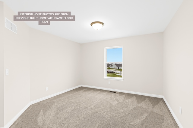 unfurnished room with carpet, visible vents, and baseboards