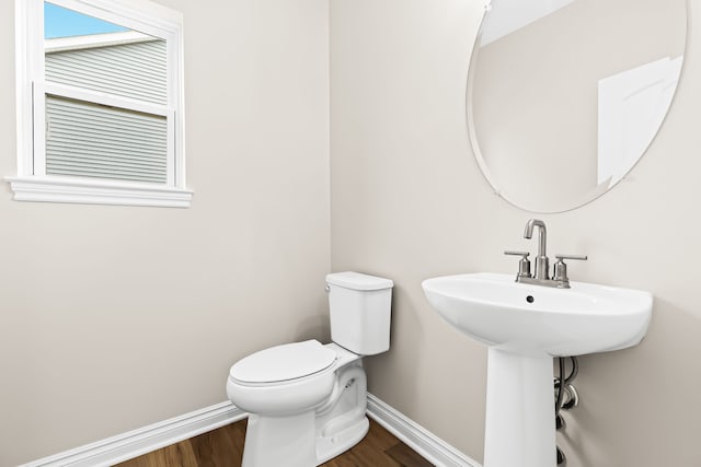 bathroom featuring wood finished floors, toilet, and baseboards