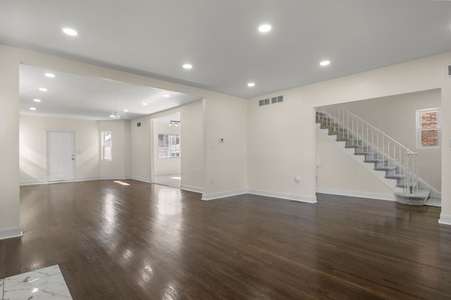 unfurnished living room featuring dark hardwood / wood-style flooring