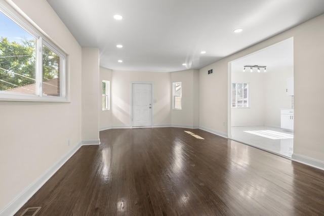 unfurnished room with dark wood-type flooring