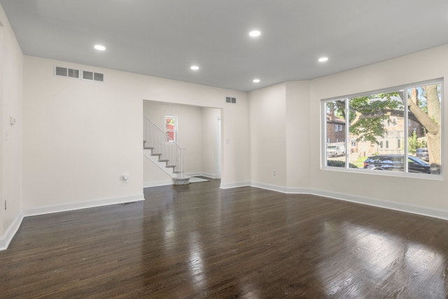 spare room featuring dark wood-type flooring