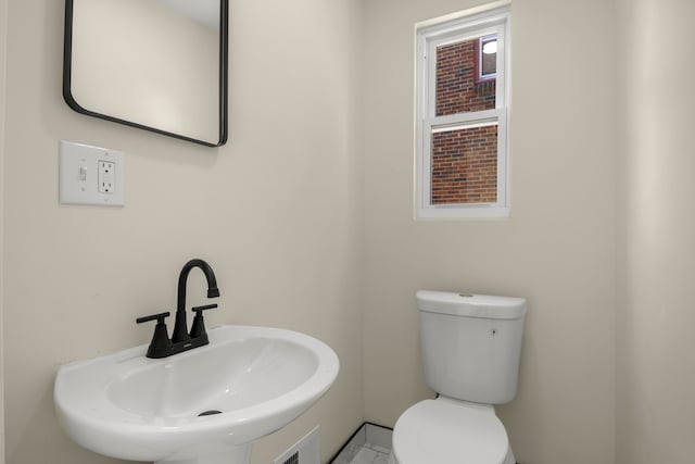 bathroom with sink and toilet