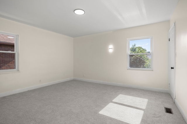 unfurnished room with light colored carpet