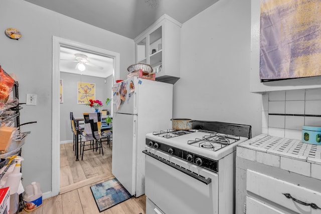 kitchen featuring white appliances, white cabinetry, ceiling fan, and light hardwood / wood-style floors