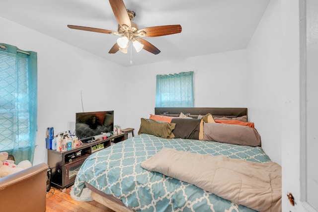 bedroom with ceiling fan and wood-type flooring