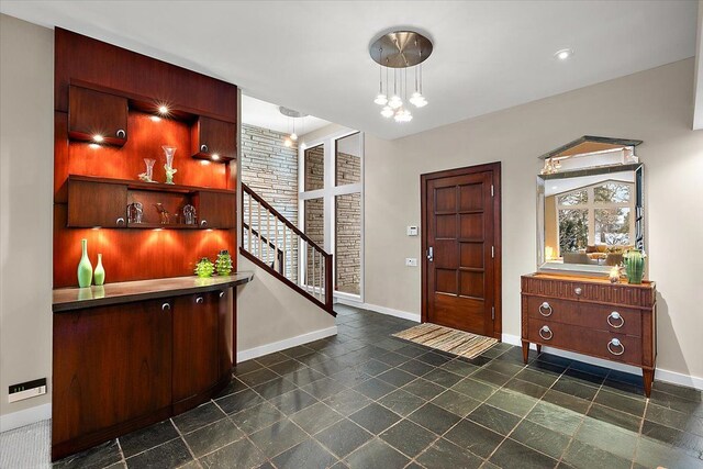 entrance foyer featuring an inviting chandelier