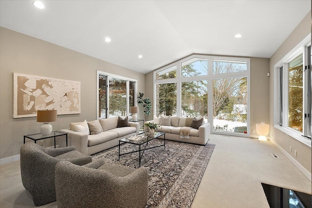 carpeted living room featuring vaulted ceiling