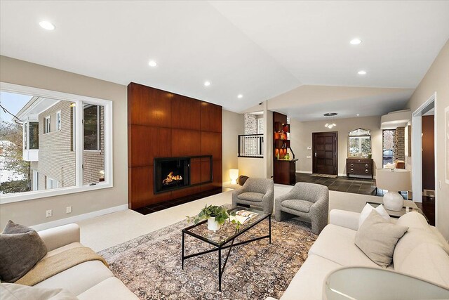 living room with lofted ceiling and a fireplace