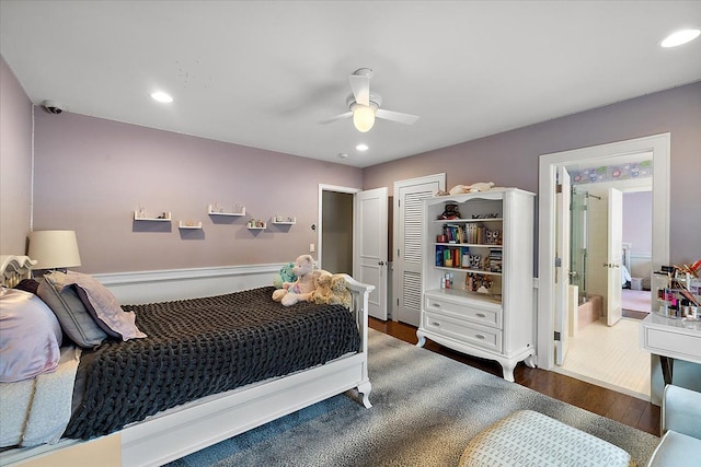 bedroom with ceiling fan, connected bathroom, dark hardwood / wood-style flooring, and a closet