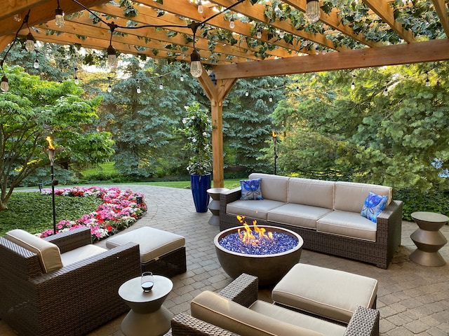 view of patio with a pergola and an outdoor living space with a fire pit