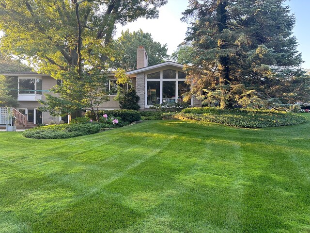 view of yard featuring a sunroom