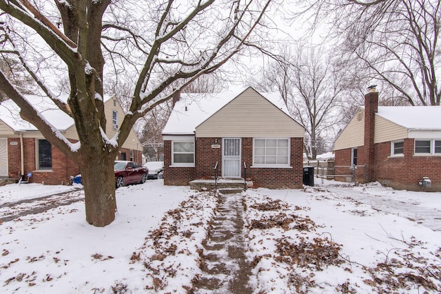 bungalow-style home with central air condition unit