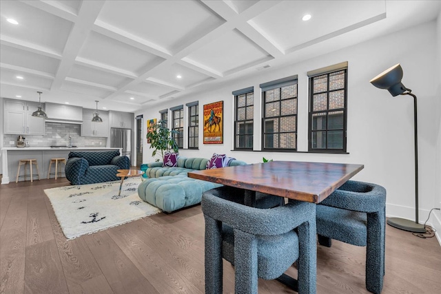 living room featuring recessed lighting, coffered ceiling, baseboards, light wood-type flooring, and beamed ceiling