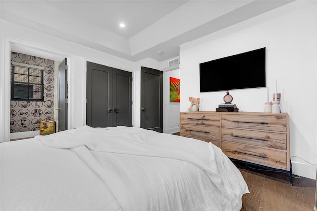 bedroom with dark wood finished floors, visible vents, and recessed lighting