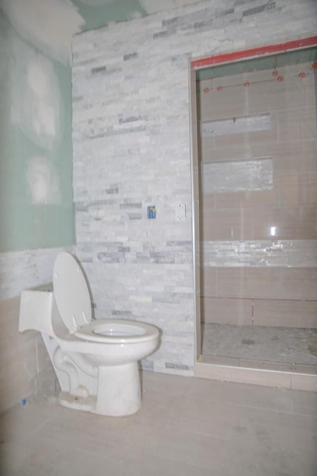 bathroom featuring tile patterned flooring and toilet