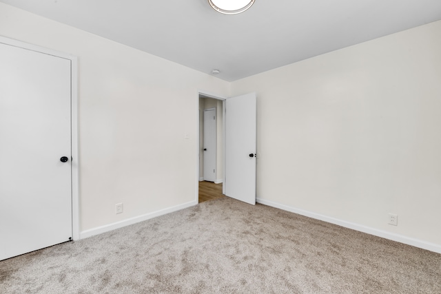 unfurnished bedroom featuring light colored carpet