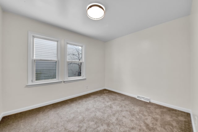 spare room with light carpet