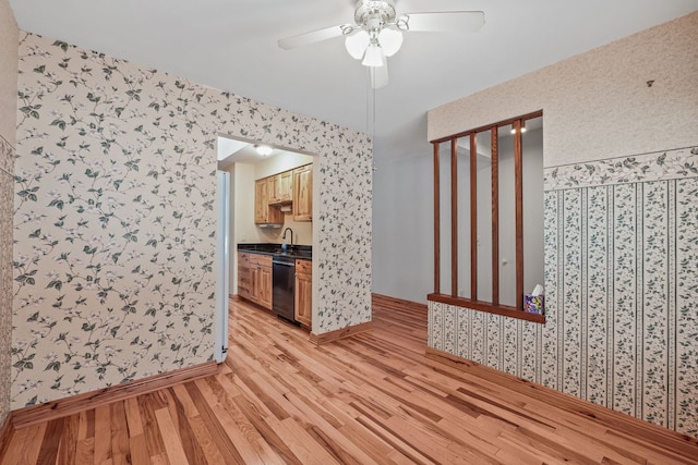 spare room featuring ceiling fan, light hardwood / wood-style floors, and sink