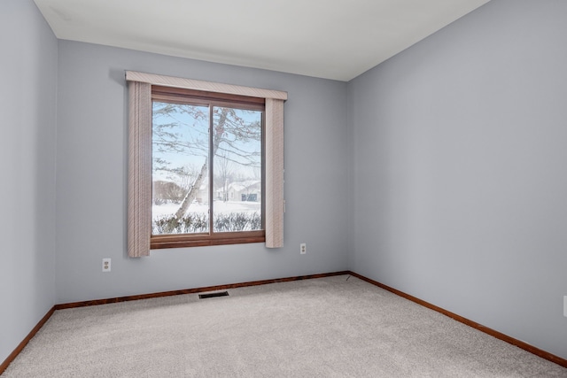 carpeted spare room featuring a healthy amount of sunlight