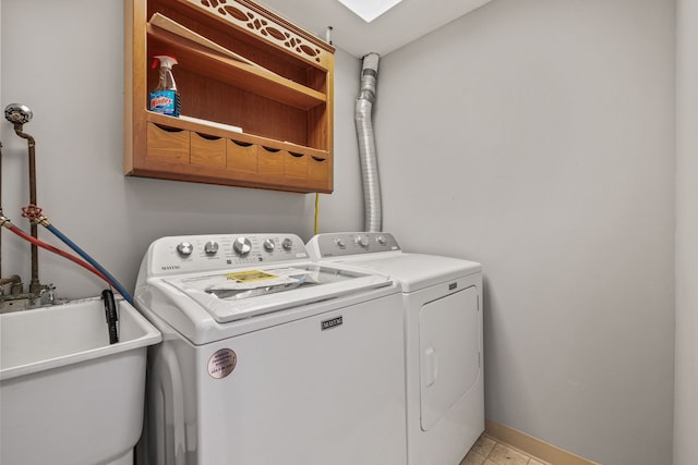 laundry area featuring sink and washing machine and clothes dryer