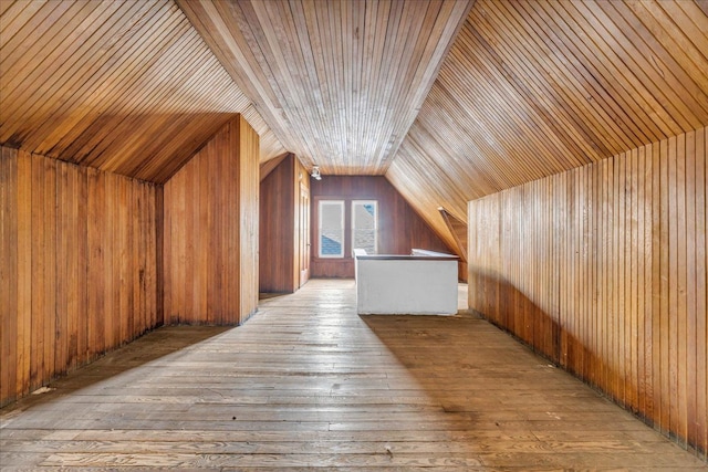 bonus room with wooden ceiling, wood walls, vaulted ceiling, and light hardwood / wood-style flooring