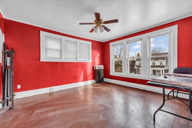 interior space featuring radiator, hardwood / wood-style floors, and ceiling fan