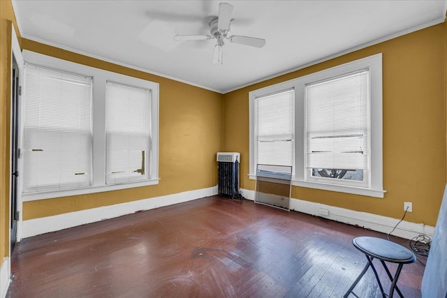 unfurnished room featuring ornamental molding, ceiling fan, and radiator