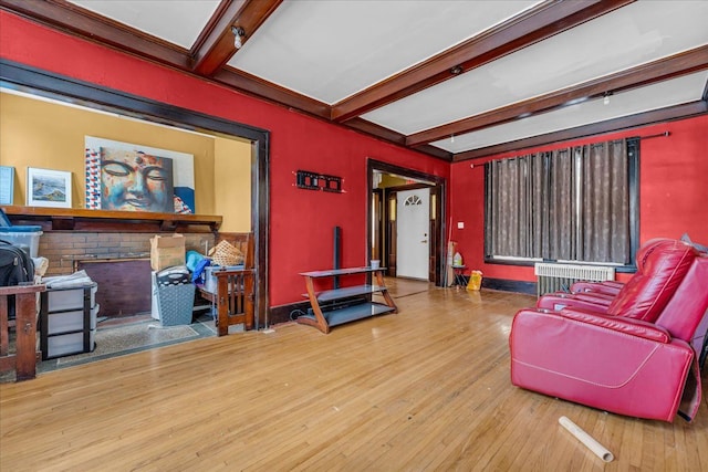 living room with radiator, hardwood / wood-style flooring, and beam ceiling